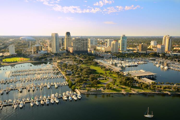 An aerial view of St. Petersburg, showing a city on the water with tall buildings.