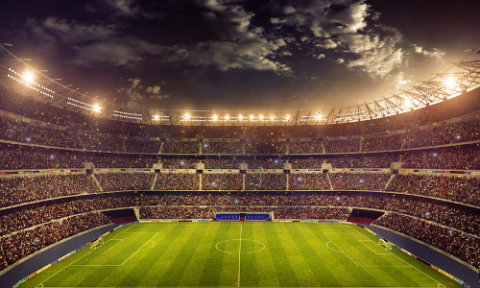 A soccer stadium with the stands full.